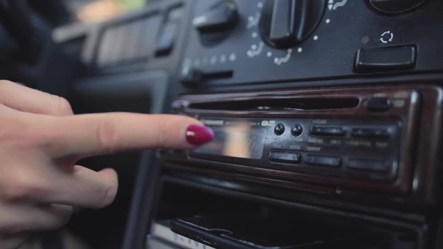 Girl Inserting Disc Into Vintage Car Radio