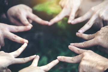 Fingers are star-shaped to represent teamwork and harmony.This image is soft focus..