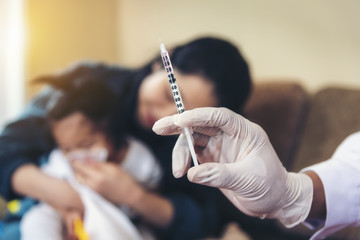 Asian doctors are checking syringes to treat children.