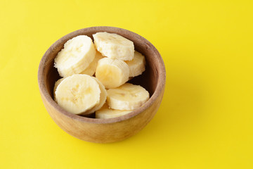 Close up view of wooden bowl with banana slices