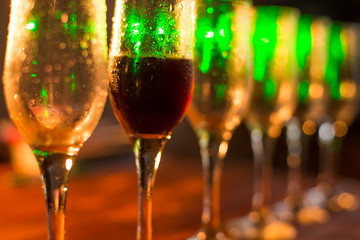 White wine pouring into glasses, close up view