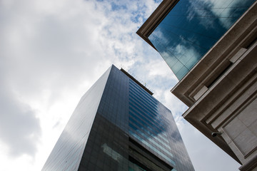 Modern architecture corporate buildings reflecting the blue sky and white clouds in their windows made of blue glass