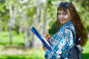 summer holidays, education, campus and teenage concept - smiling female student with folders