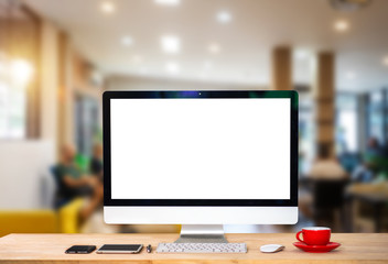 Workspace with computer Monitor, Keyboard,blank screen coffee cup on a table in bright office room...