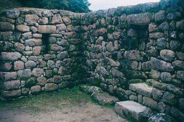 Stone magical ancient ruins along the paved path Inca Trail to Machu Picchu in Peru.