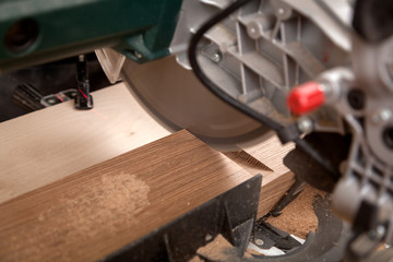 Close up carpenter work with circular saw for cutting boards, the man sawed bars, construction and home renovation, repair and construction tool