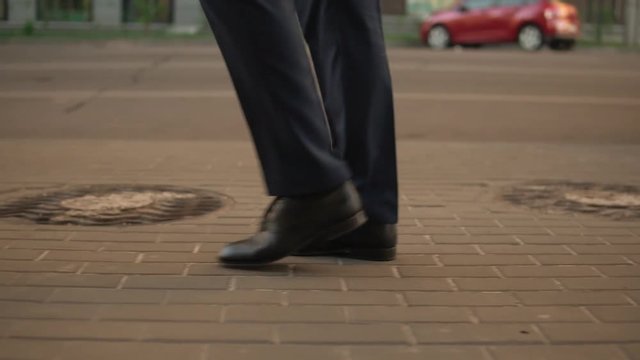 blonde haired man looking confident and independent. fairhaired wears black shoes and blue suit.