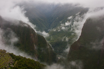 Green wild jungle valley with fog from a high point of view on the Andes along the Inca Trail. Peru. South America. No people.