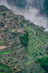 Obraz premium The secret and mysterious ruins of Machu Picchu covered in mist with the high Andes mountains on the background. The amazing prize of hiking the Inca Trail in Peru, South America.