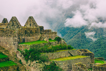 Ruins of houses and farming terraces on a cliff at Machu Picchu. Peru. South America. No people.