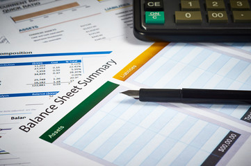 balance sheet summary and balance sheets with calculator and pen