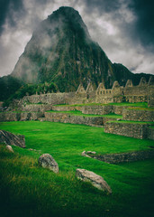 The day start with intense mist in the air in Machu Picchu. The historic archaeological site in a mysterious ambience. Beautiful wallpaper image.