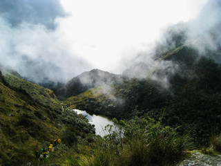 Serene lake water in the wild jungle nature of the mountains with mist along the Inca Trail. Peru. South America. No people.
