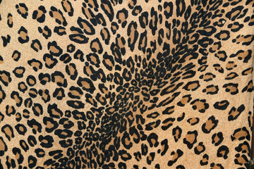 Closeup fabric pattern of leopard tiger, in black brown orange and cream color.