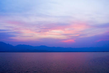 landscape of clouds sky sunset over lake with mountains