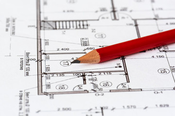 The architectural plan of the house is printed on a white sheet of paper. A red pencil on it. June 2018, Russia, Moscow