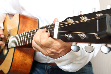 Hands of a musician playing classical acoustic guitar