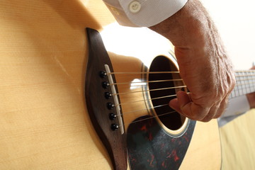Hands of a musician playing classical acoustic guitar