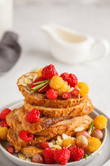 French toast with berries and syrup, vertical. Healthy vegan food concept.