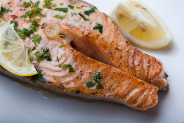 Salmon slice with a lemon and green parsley