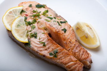 Salmon slice with a lemon and green parsley