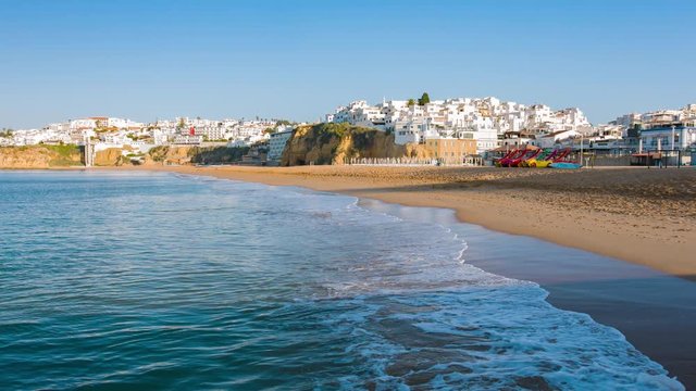 Old town white houses and ocean beach in Portugal town Albufeira