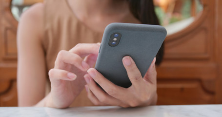 Woman use of cellphone in coffee shop