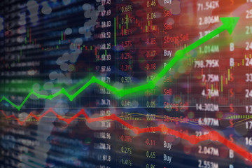 Investing and stock market concept gain and profits with faded candlestick charts.