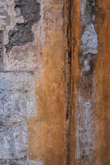 Vertical image of worn concrete wall. Peeling plaster on a cement wall.