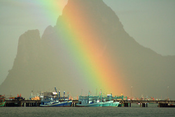 boat sea rainbow mountain range