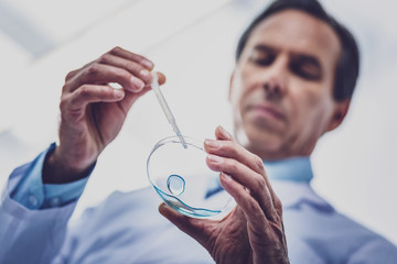 New chemicals. Elderly experienced bioengineer feeling very motivated while testing new...