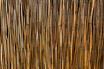 Beautiful wallpaper image of a fence made of bamboo sticks. Recycling materials from nature. No people.