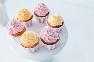 selective focus of delicious cupcakes on stand at table