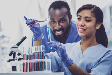 Smart biologists. Two skillful smart promising biologists working with test tubes of liquids...