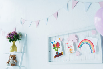 decorated for birthday room with balloons and child paintings