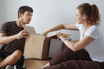 Young cute couple just married sitting on floor