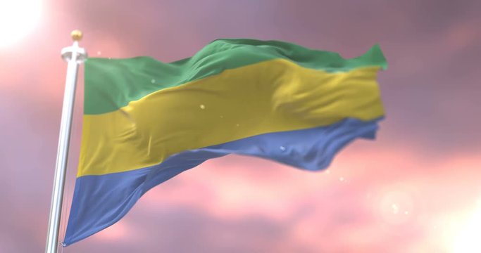 Flag of Gabon waving at wind at sunset in slow, loop