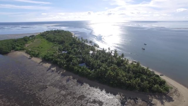 Orbital drone shot of Robinson Crusoe Island in Fiji. Beautiful place to holiday.