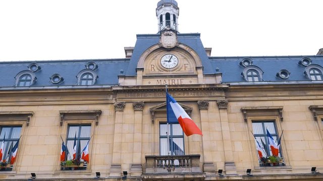 Waving French flag in front of Mairie de Saint-Ouen 93400 France