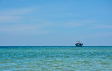 lonely fishing schooner in a quiet turquoise sea