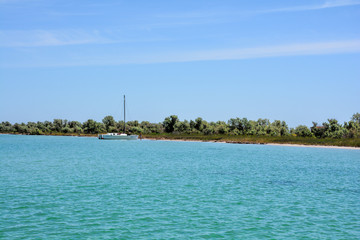 catamaran on the uninhabited coast of the turquoise sea