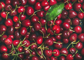 Obraz na płótnie Canvas Fresh sweet cherry texture, wallpaper and background. Flat-lay of wet sweet cherries, top view. Summer food or local market produce concept