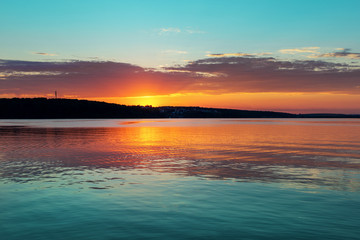 Gorgeous orange teal sunset on huge calm lake