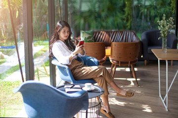 Portrait of beautiful asian woman listening to her music from Smartphone