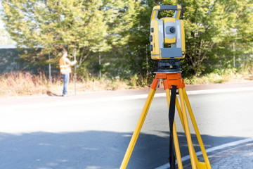 Civil Engineers At Construction Site using an altometer Surveyor equipment tacheometer outdoors
