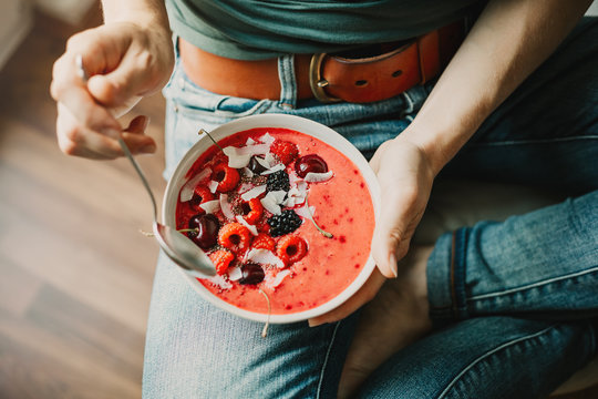 Woman eating healthy smoothie bowl
