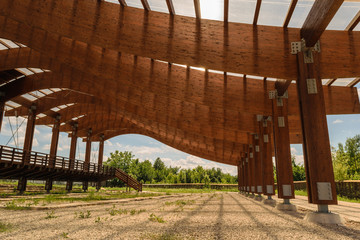 massive wood beams roof structure mounted with metal shape connectors and screws, nuts and bolts.