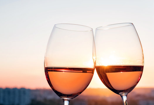 Two glasses with rose wine at sunset light.