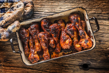 Grilled roasted and barbecue chicken legs in pan