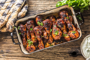 Grilled roasted and barbecue chicken legs in pan